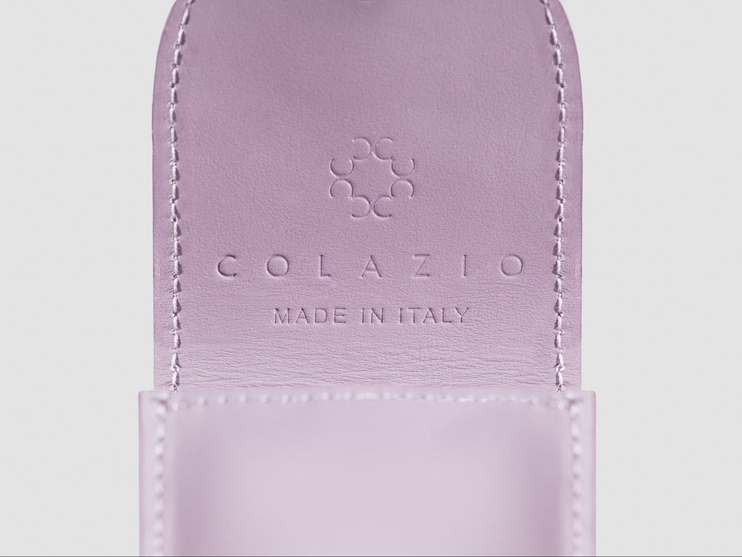 Purple leather pouch with 'Colazio Made in Italy' branding on a light gray background